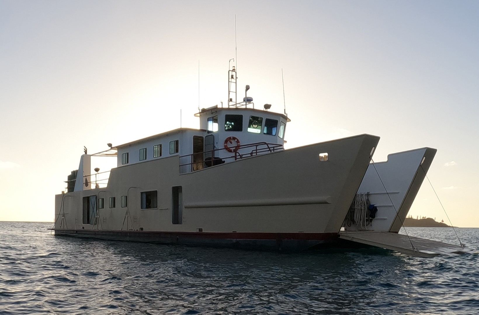 Processor1, a steel landing barge, at anchor at sunset